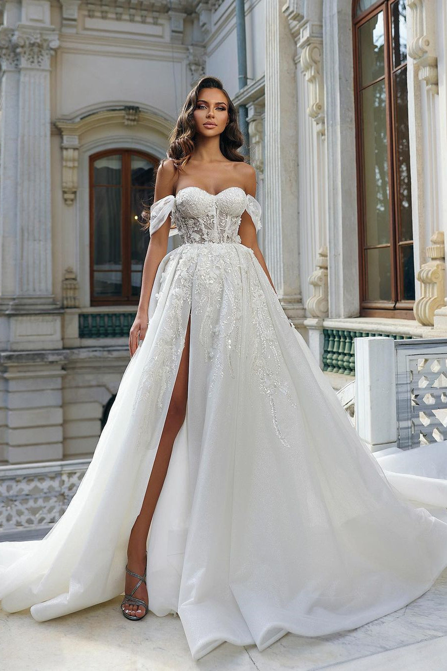 Beautiful Long White A-line Off-Shoulder Lace Wedding Dress with Delicate Floral Accents and a Slit